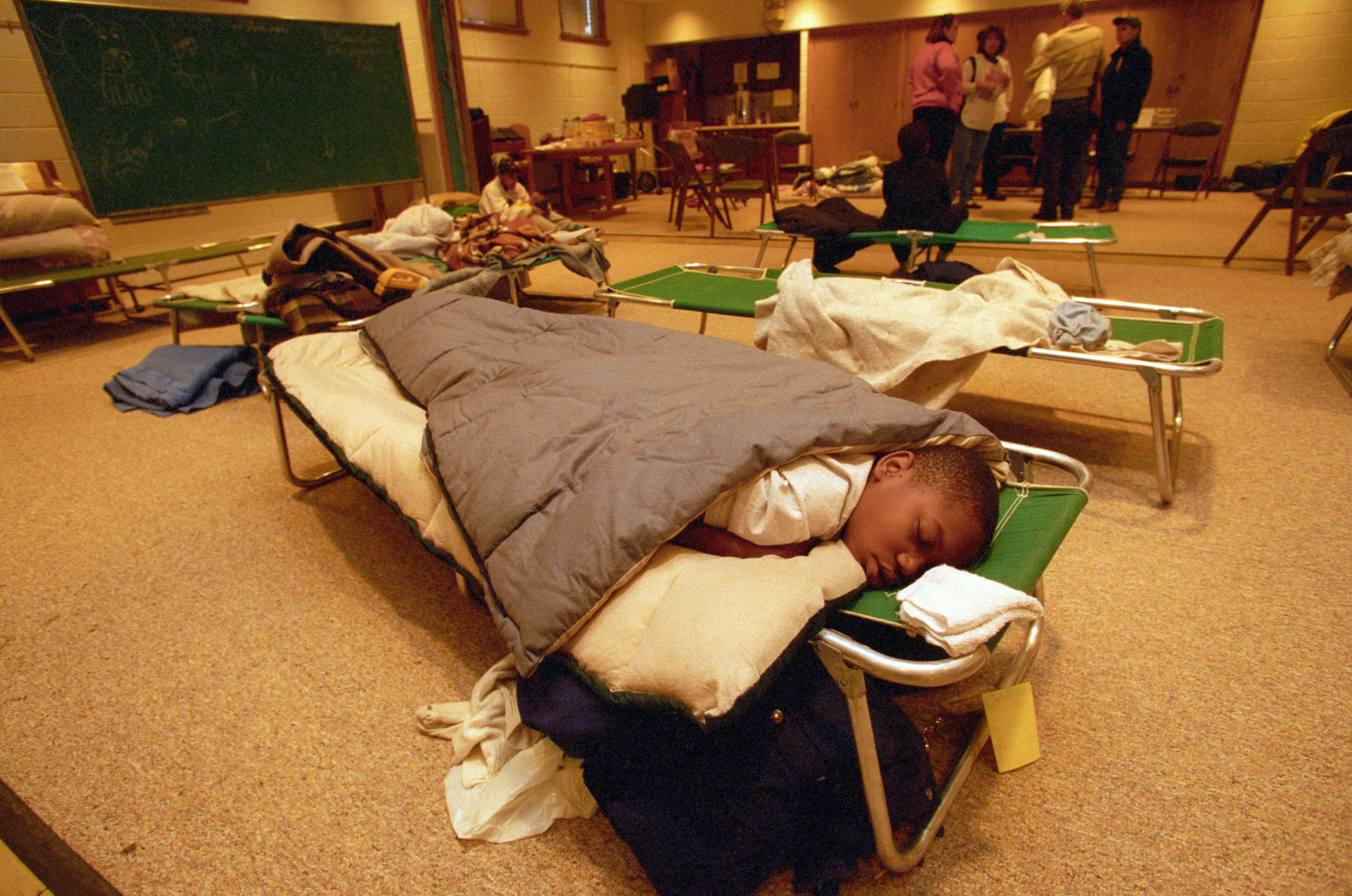 James Brookings Spurlock sleeps at the American Red Cross shelter at St. Paul Methodist Church, 5410 Corby St., on Oct. 27, 1997. The 12-year-old was at the shelter with his family members after their home lost power in the infamous snowstorm.